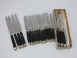 six knives in a wooden box with a box of matches