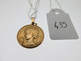 an image of a gold medal on a chain with a price tag
