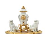 an image of a white and gold figurine with a clock and two dogs