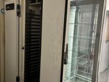 an image of a refrigerator in a building with a glass door