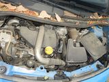a blue car with its hood open and the engine in the trunk