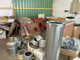 a lot of metal items in a room with a green wall
