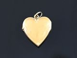 a close up of a heart shaped locke on a black surface