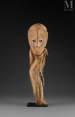 an image of a wooden mask with long hair on a stand