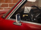 a close up of a red car with a steering wheel