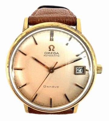 an image of a gold watch with a brown leather strap