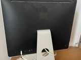 a computer monitor and keyboard sitting on a desk