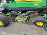 a lawn mower that is parked on the side of the road
