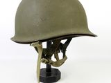 an army helmet on a stand on a white background