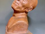 a clay sculpture of a man with a bald head