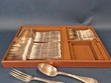 an assortment of silverware including spoons, forks and spoons in a wooden box
