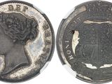 gros plan d'une pièce de monnaie sur laquelle figure une tête de femme