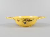 an image of a yellow bowl with birds and flowers on it