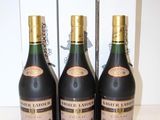 three bottles of champagne sitting next to each other on a table