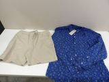 blue shirt and khaki shorts on a white table