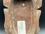 a wooden vase that has a tag on it