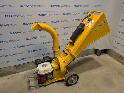 a close up of a small yellow machine on a concrete floor