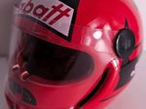 a red helmet with a sticker on it sitting on a table