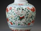 a white vase with a painting on it sitting on a table