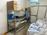 many bags of food sitting on a shelf in a room