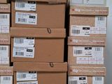 boxes stacked on top of each other on a table in front of a wall