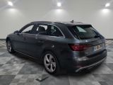 the rear end of a grey audi wagon parked in a garage