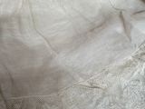 a white dress on a bed next to a pillow