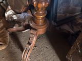 a wooden table with a metal object on top of it