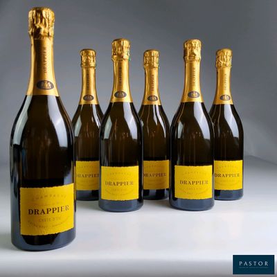 six bottles of champagne are lined up in a row