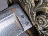 a close up of a knife on a stand