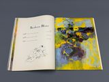 an open book with a picture of a woman and flowers