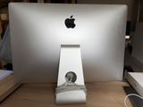a white apple computer sitting on a desk with a keyboard and mouse