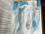 someone is holding a book with a drawing of a woman on it