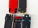 four small toy cars sitting next to each other on a white surface