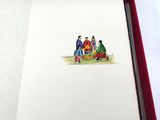 un livre ouvert sur lequel figure le dessin d'un groupe de personnes assises sur un banc
