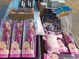 boxes of barbie dolls are on a table in a store