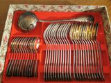 a red tray with silverware in it on a table
