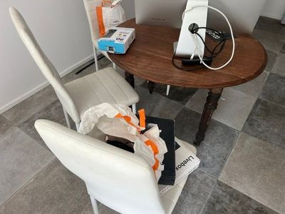 a table with two chairs and a table with a phone on it