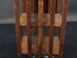 an old wooden table with three shelves on top of it