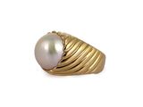an image of a gold ring with a pearl in it