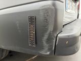 a close up of a car ' s bumper with a ruler on it