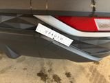a sticker on the bumper of a car that has a tag attached to it