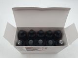 six bottles of soda in a box on a white surface