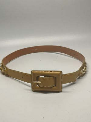 a gold belt with a metal buckle on a white background