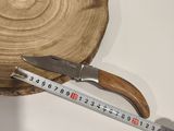 a person measuring a piece of wood with a measuring tape