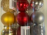 de nombreuses décorations de Noël de différentes couleurs dans un récipient transparent