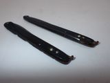 two black hair clips on a white table