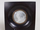 a black plate with a picture of a woman on it
