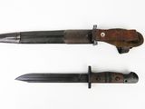 two knives are shown side by side on a white surface