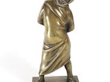 bronze statue of a man with a hood on his head holding a baseball bat